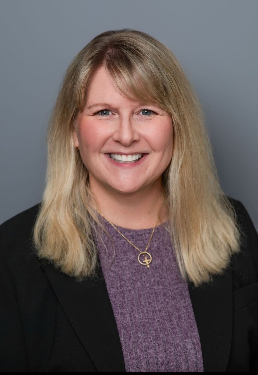 Smiling blonde woman in professional headshot