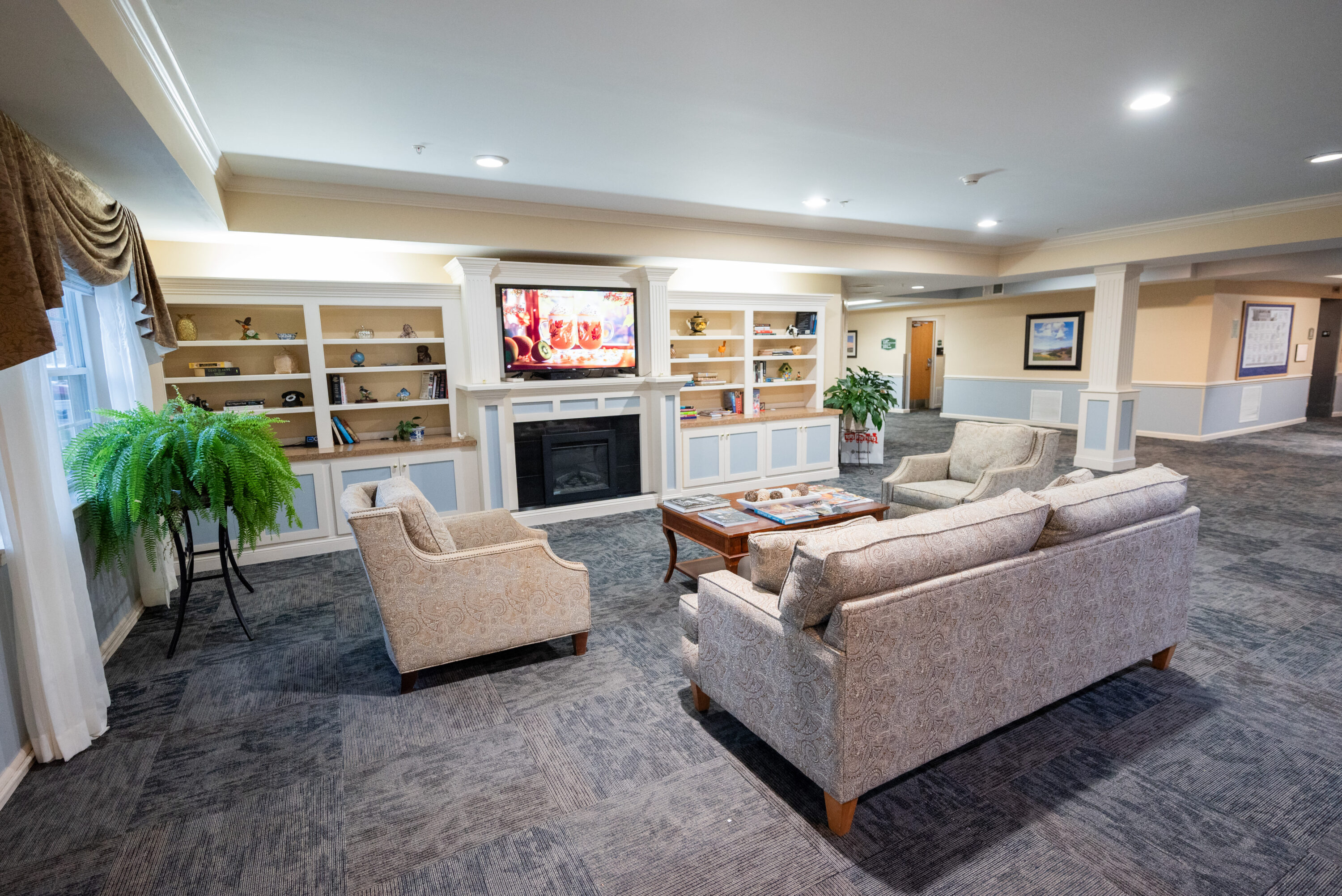Cozy lounge with fireplace, TV, and seating area